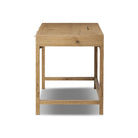 Side of Four Hands Tula Writing Desk in Worn Oak Veneer on a white background at Addison West