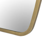 Close up Four Hands Vault Mirror in Antique Brass on a white background at Addison West