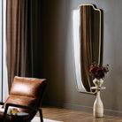 Four Hands Vault Mirror in Antique Brass in a living room at Addison West