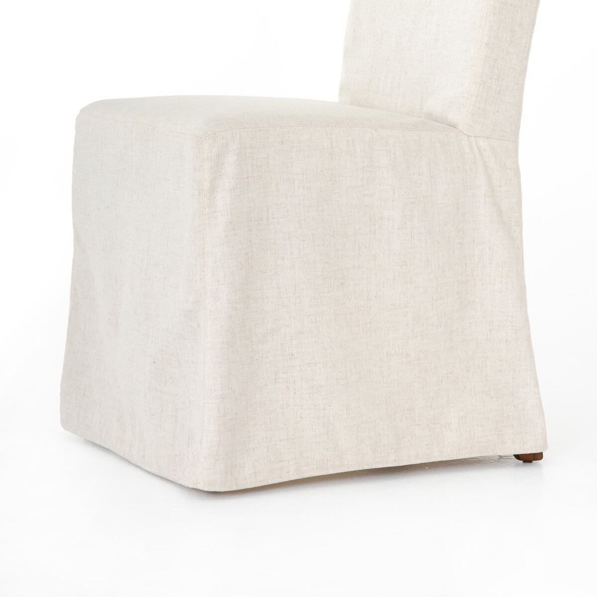 Close up of Four Hands Vista Slipcovered Dining Chair in Savile Flax on a white background