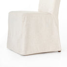 Close up of Four Hands Vista Slipcovered Dining Chair in Savile Flax on a white background