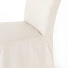 Close up of Four Hands Vista Slipcovered Dining Chair in Savile Flax on a white background