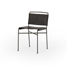 Four Hands Wharton Dining Chair in Distressed Black on a white background at Addison West