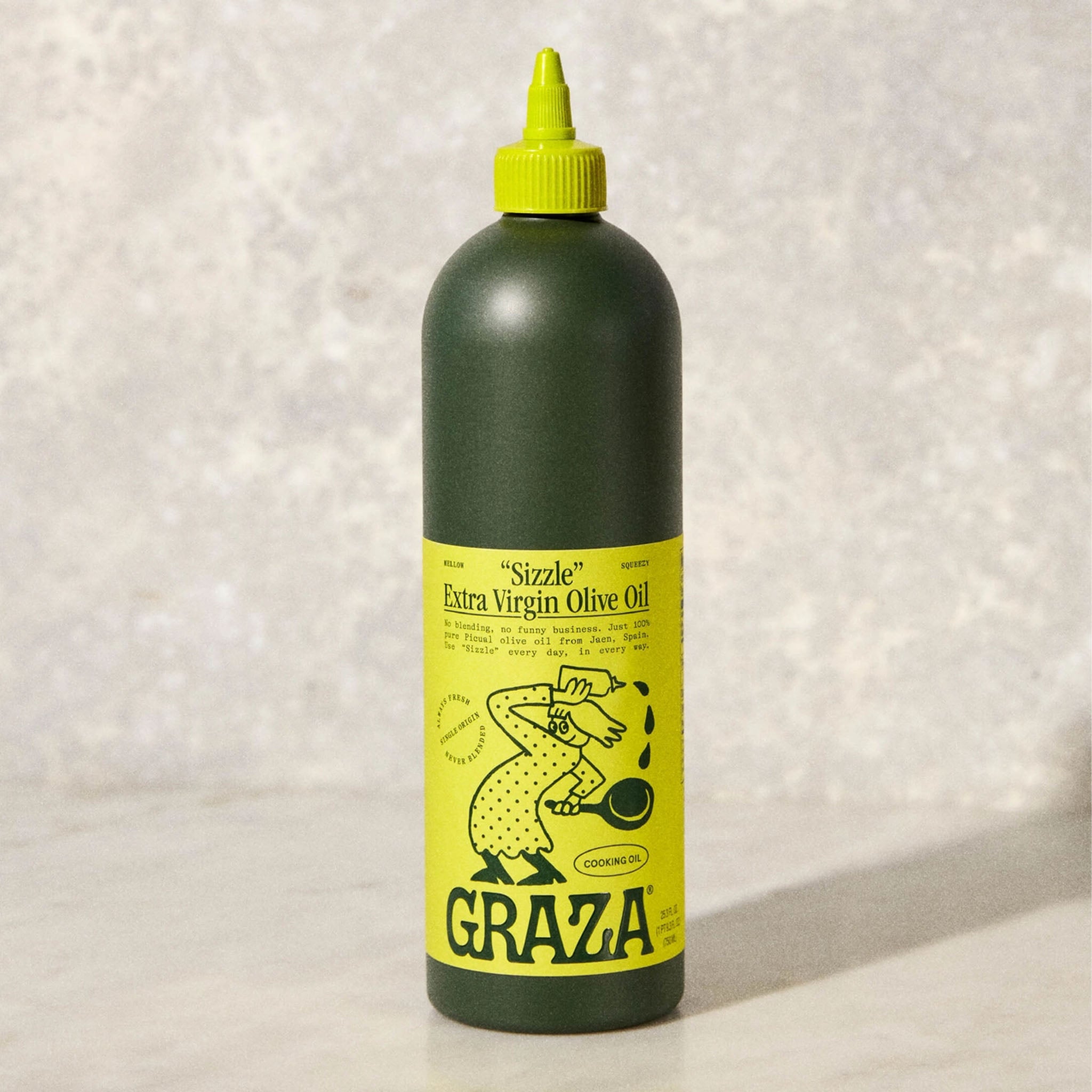 Graza Sizzle Olive Oil on a grey surface