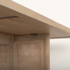 Close up of Grier 84 inch long Light Brown Wood with Cane Dining Table on a white background