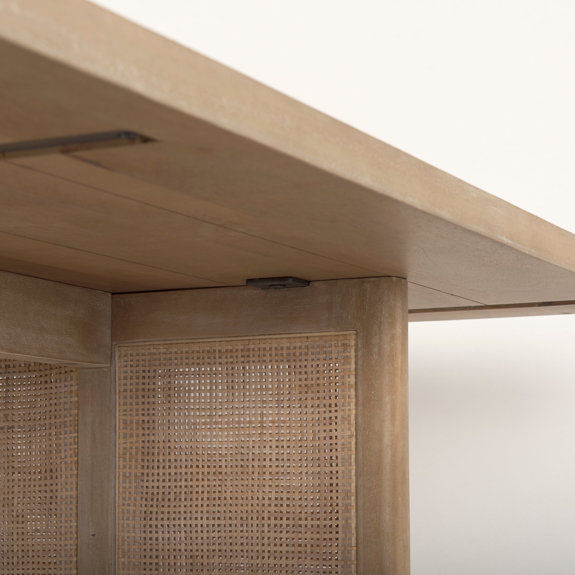 Close up of Grier 84 inch long Light Brown Wood with Cane Dining Table on a white background