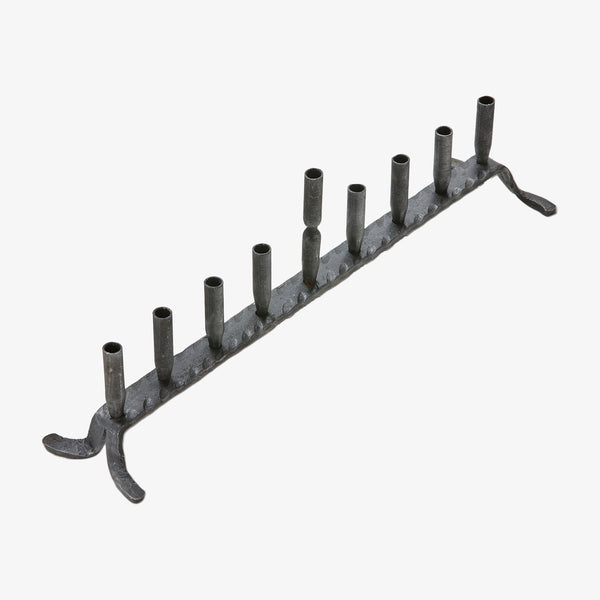 Iron forged menorah with nine candle holders on a white background