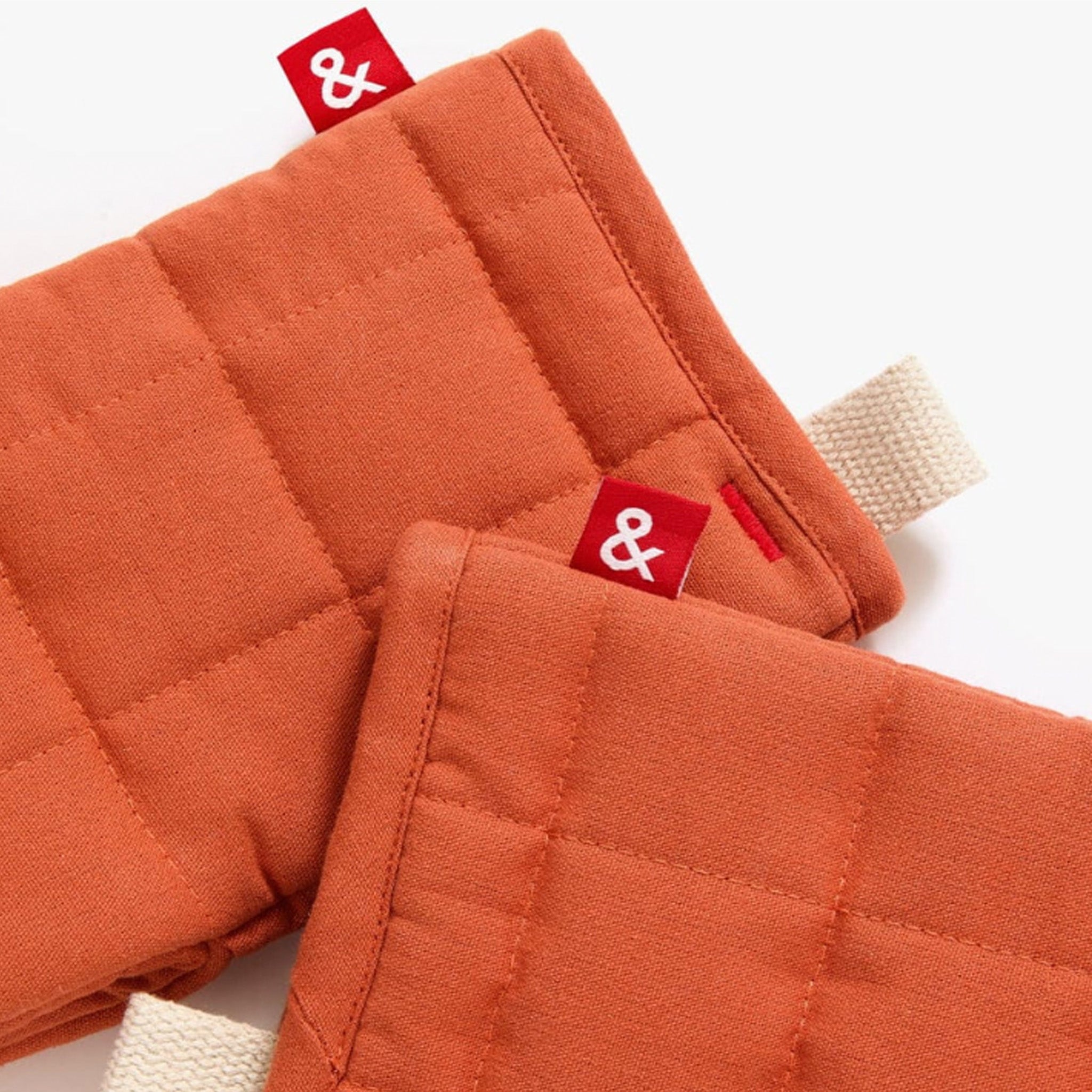 Hedley & Bennett Paprika Oven Mitts on plain background at Addison West.
