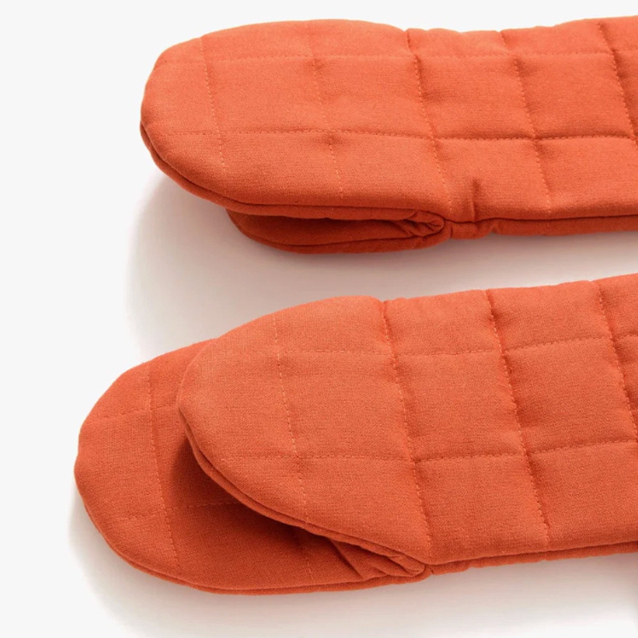 Hedley & Bennett Paprika Oven Mitts on plain background at Addison West.