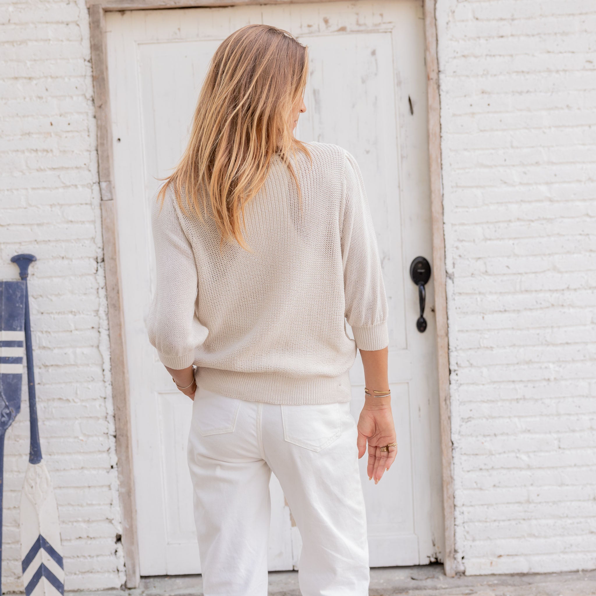 Wooden Ships Justine 3/4 Sleeve V Top Mercer in Half Moon on a model in front of a while wall at Addison West