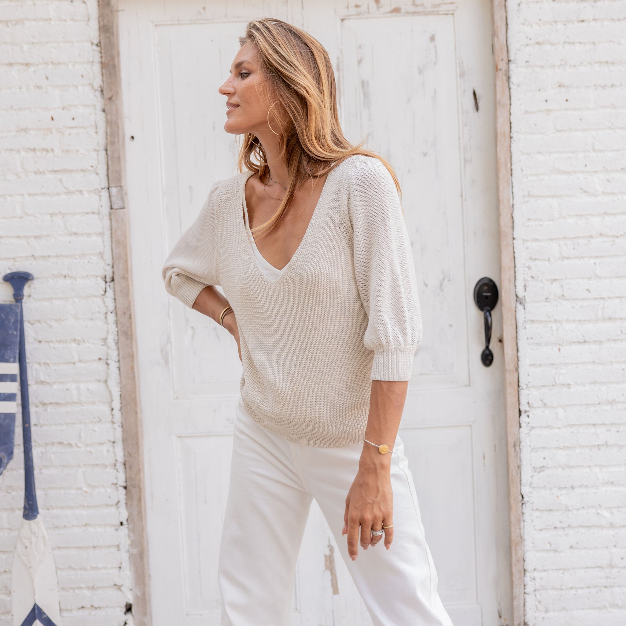 Wooden Ships Justine 3/4 Sleeve V Top Mercer in Half Moon on a model in front of a while wall at Addison West