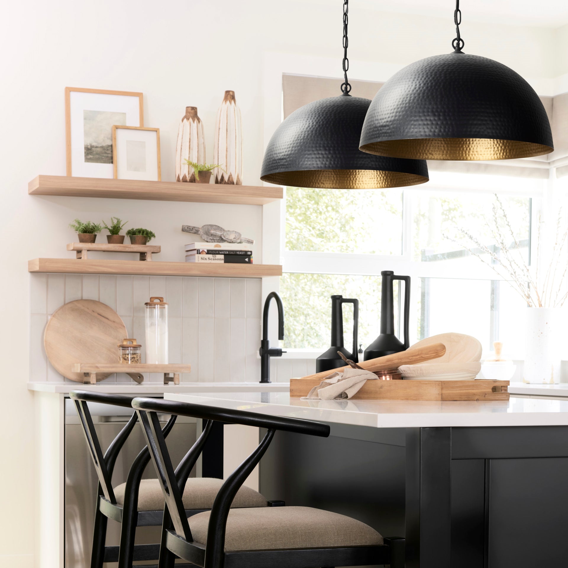 Karina 24" Round Matte Black Hammered Metal Dome Pendant Light in a modern farmhouse kitchen