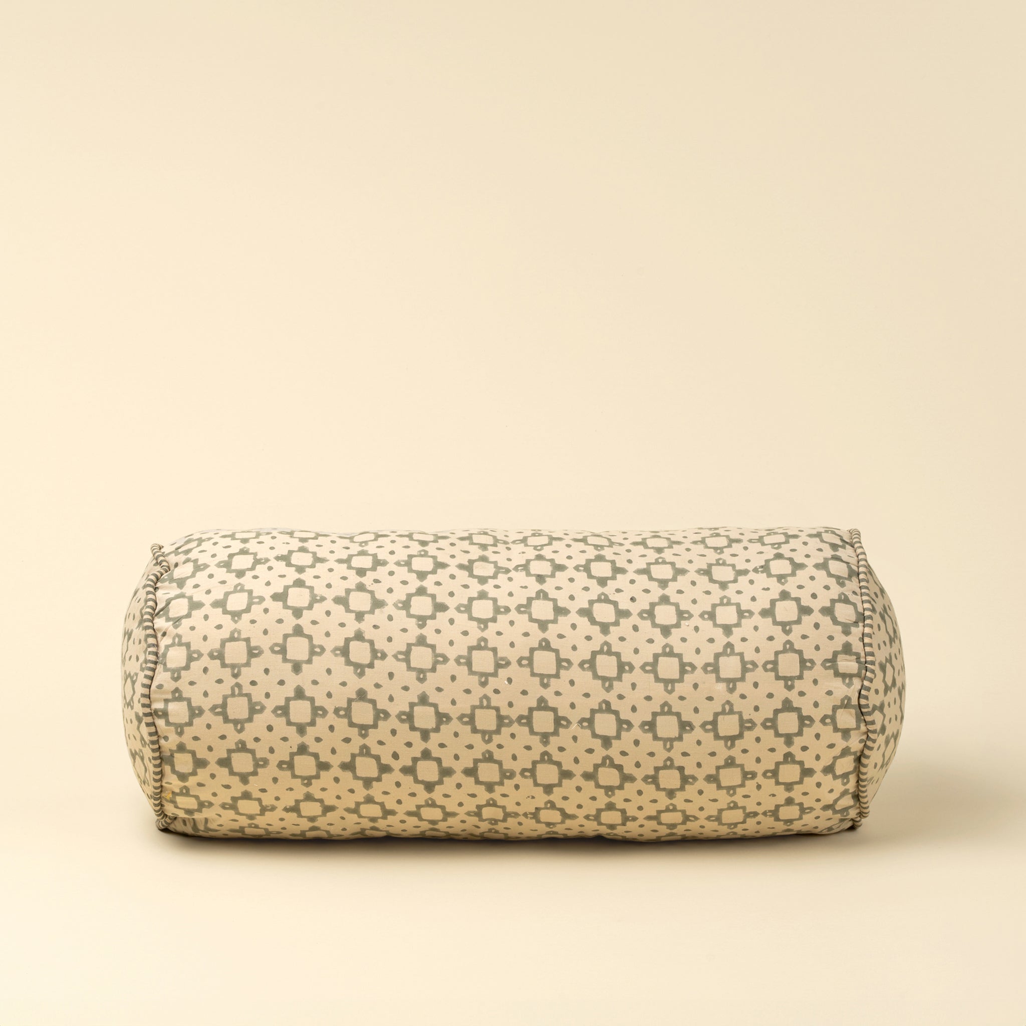 Kiran Block Print Bolster on a beige background at Addison West