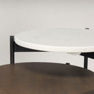 Round nesting side tables with black frames on a white background