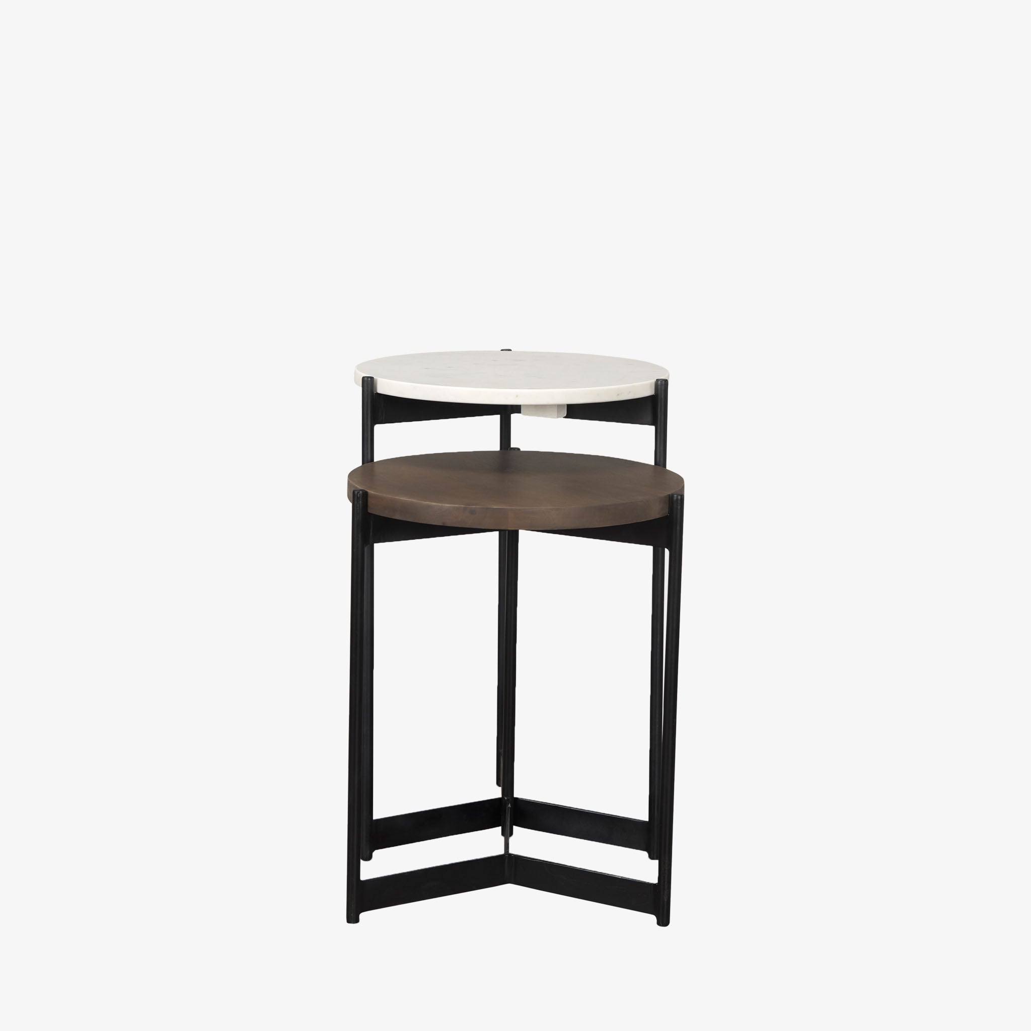 Round nesting side tables with black frames on a white background