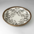 Ceramic bowl with decorative design of squirrels and acorns on a white background