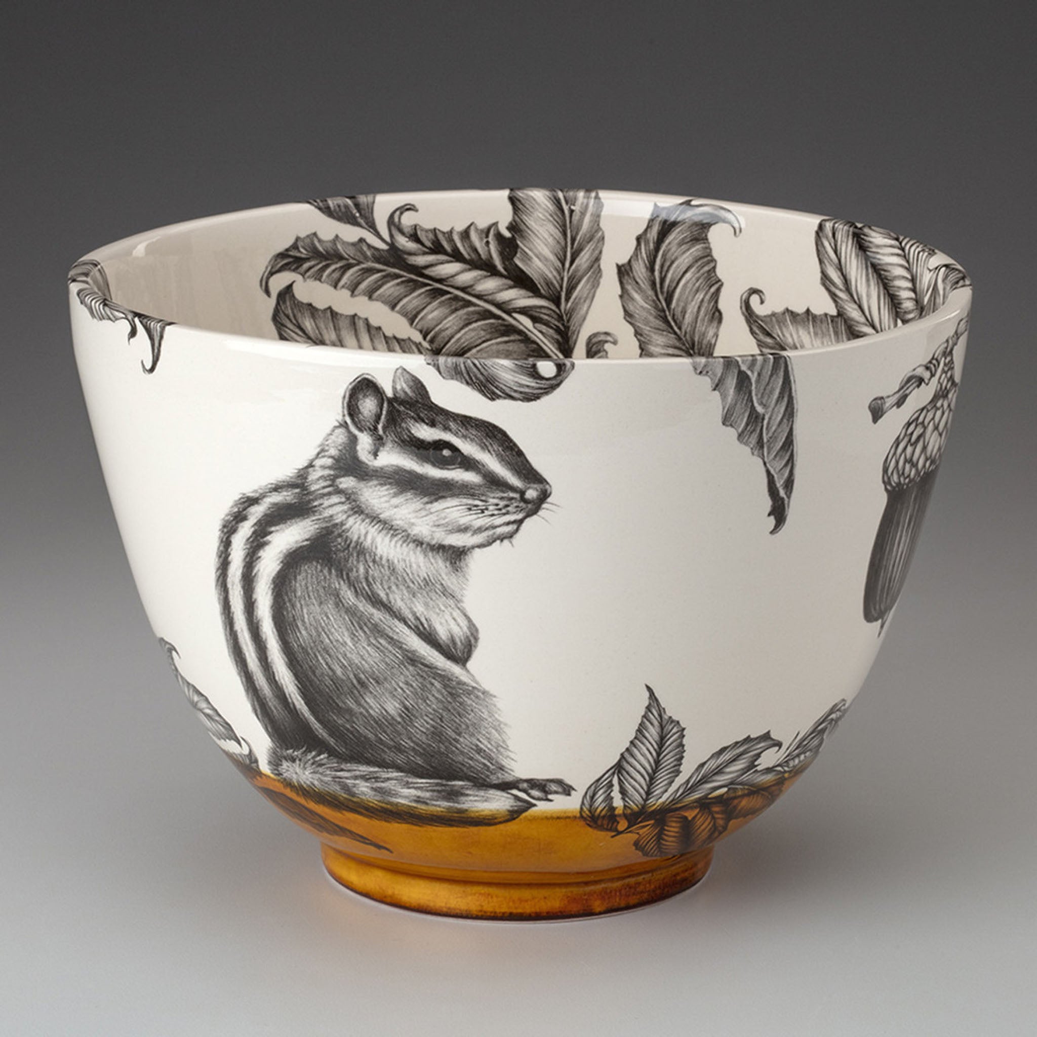 Ceramic bowl with a design of a chipmunk and leaves on a white background