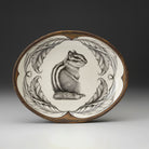 Decorative plate with a chipmunk design on a plain background