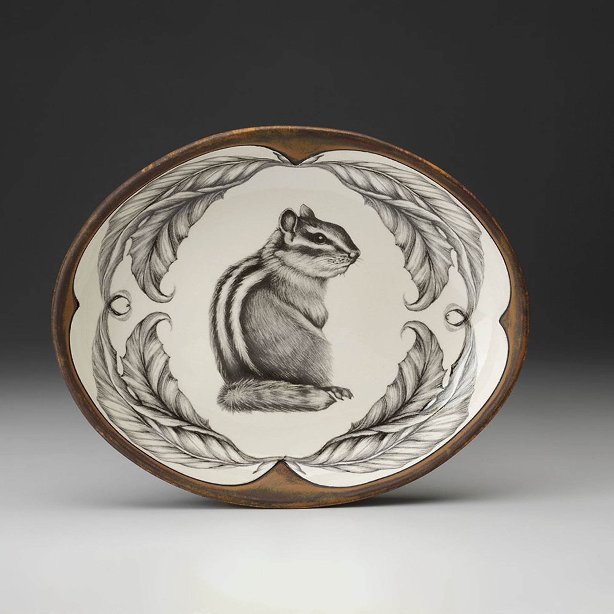 Decorative plate with a chipmunk design on a plain background