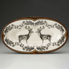 Decorative platter with deer design on a plain background