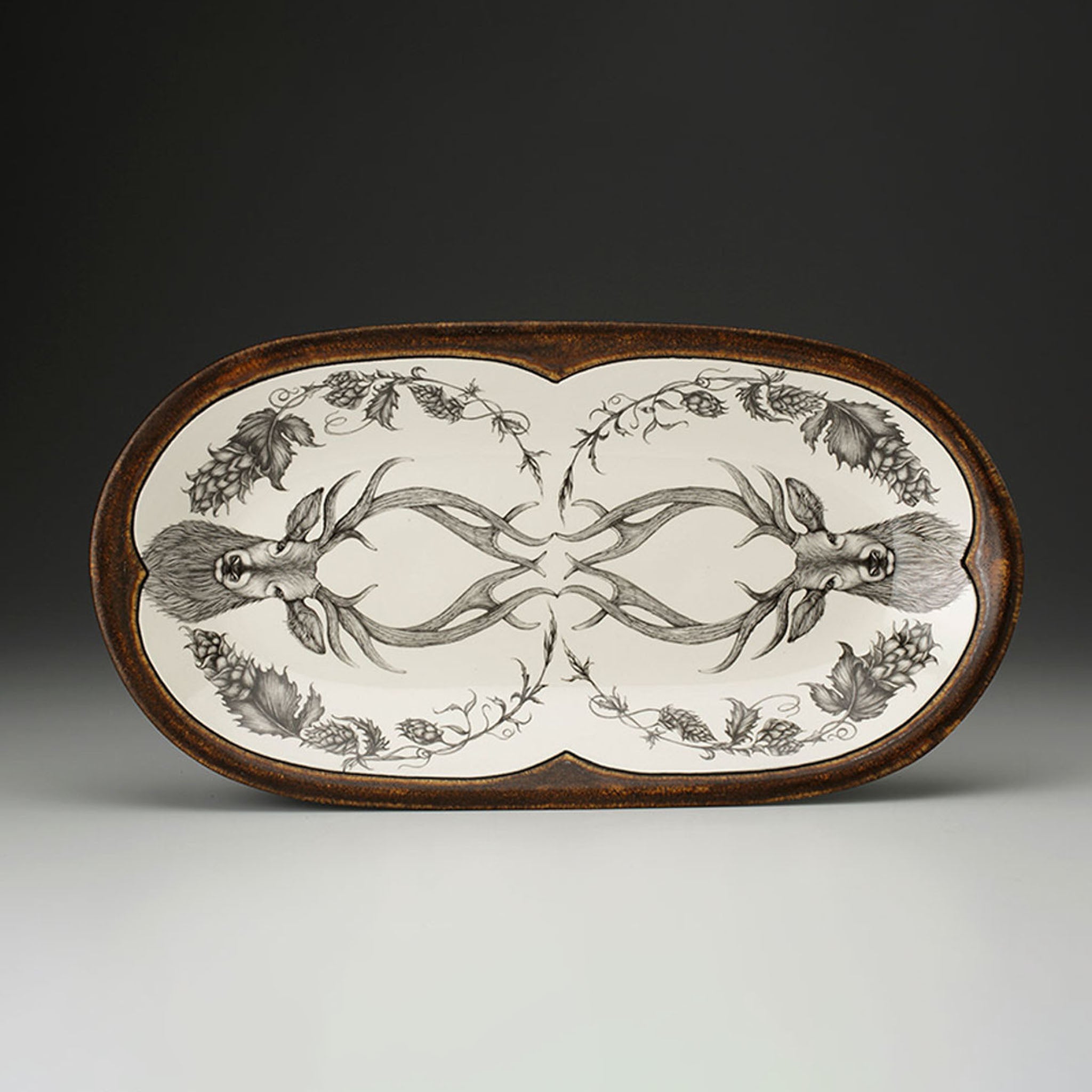 Decorative tray with deer antler design on a dark background