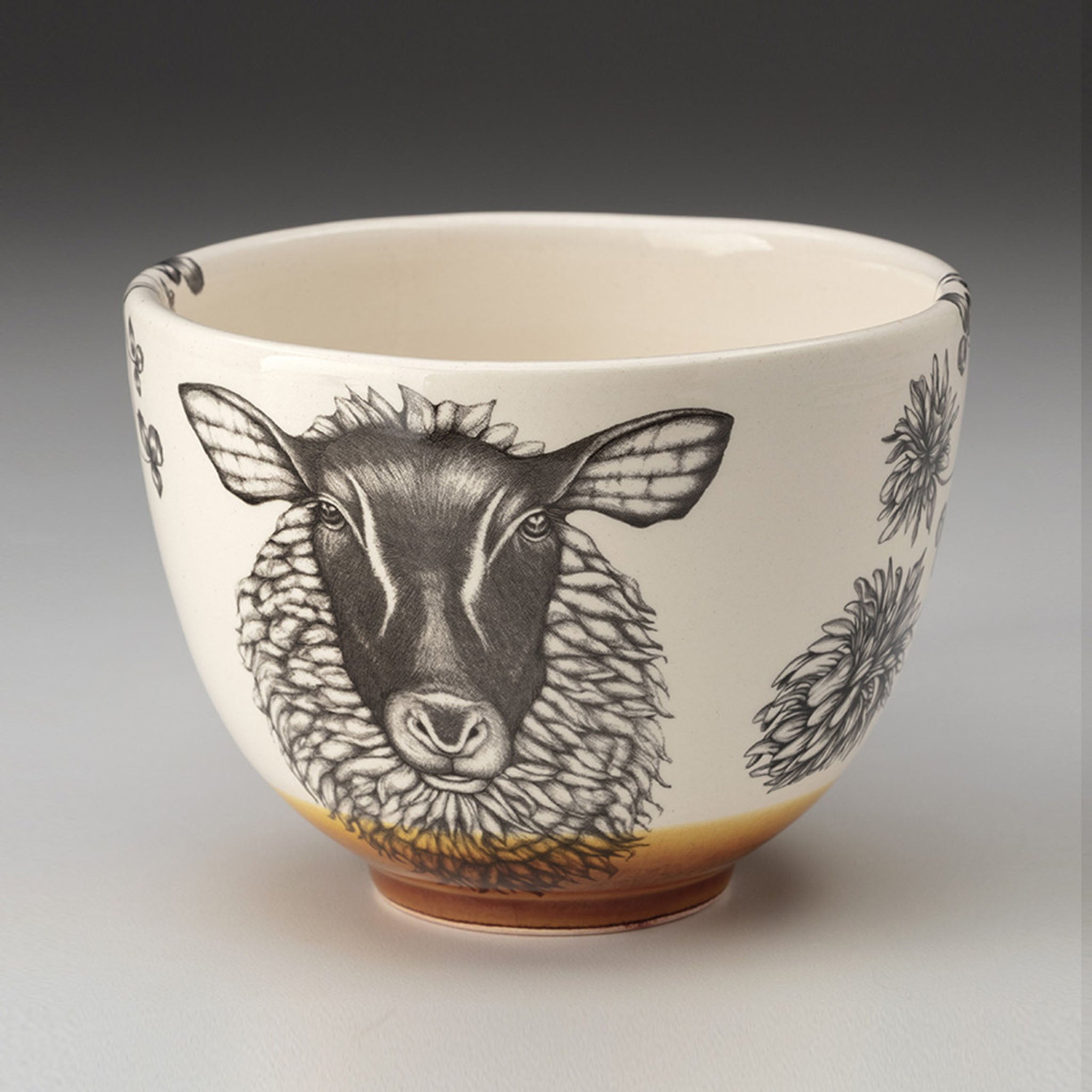 Ceramic bowl with a black and white sheep illustration on a beige background