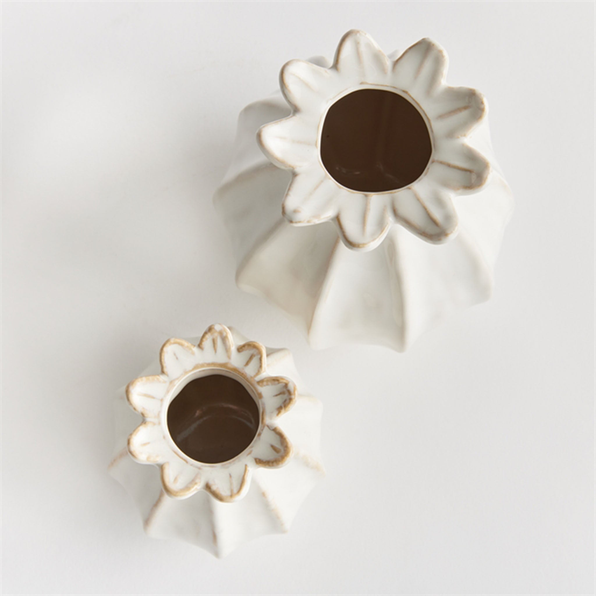 Small and large sculpted bud vase in white from Addison West home goods on a white background