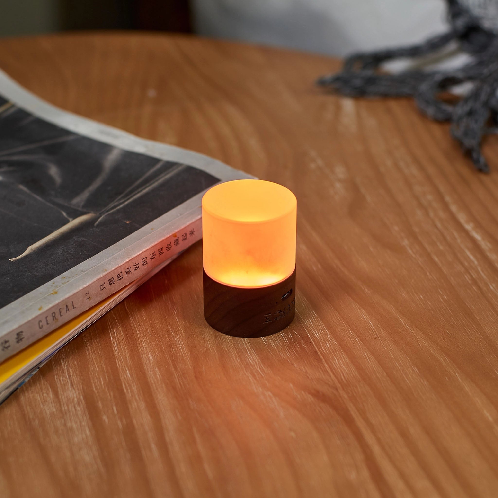 Mini Lemelia Light in Walnut on a wood table at Addison West
