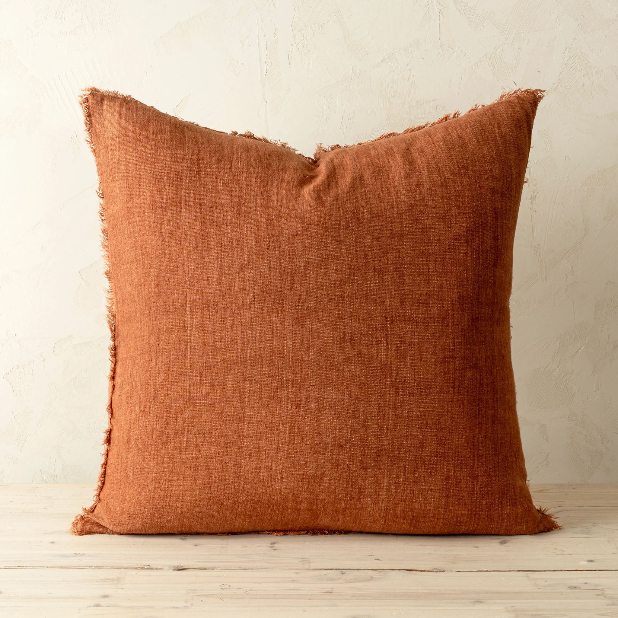 Lina Linen 24" Pillow in Burnt Umber on a beige background at Addison West