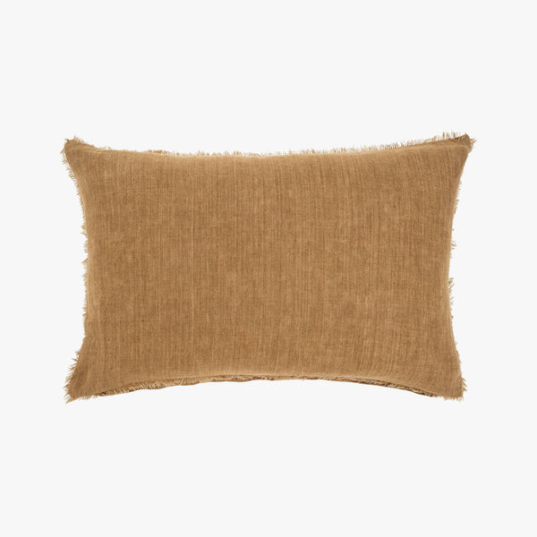 Linen lumbar pillow with frayed edges in tawny brown on a white background