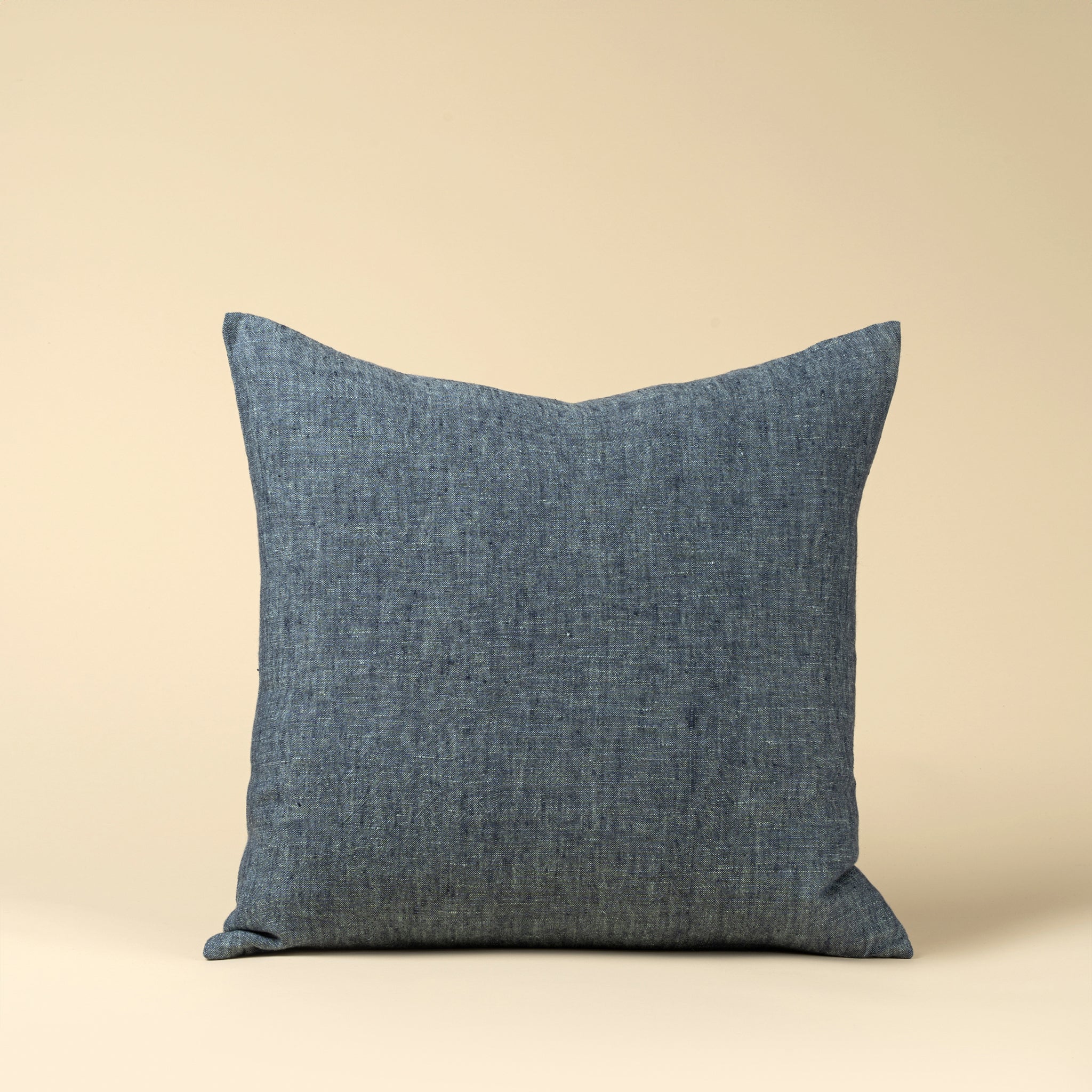 20" Linen Chambray Pillow in Denim on a beige background at Addison West