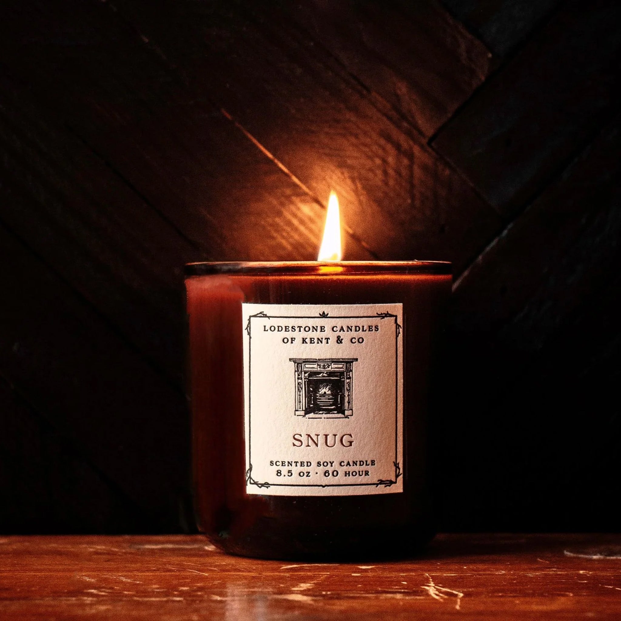 Lodestone Snug Candle on a wood background at Addison West