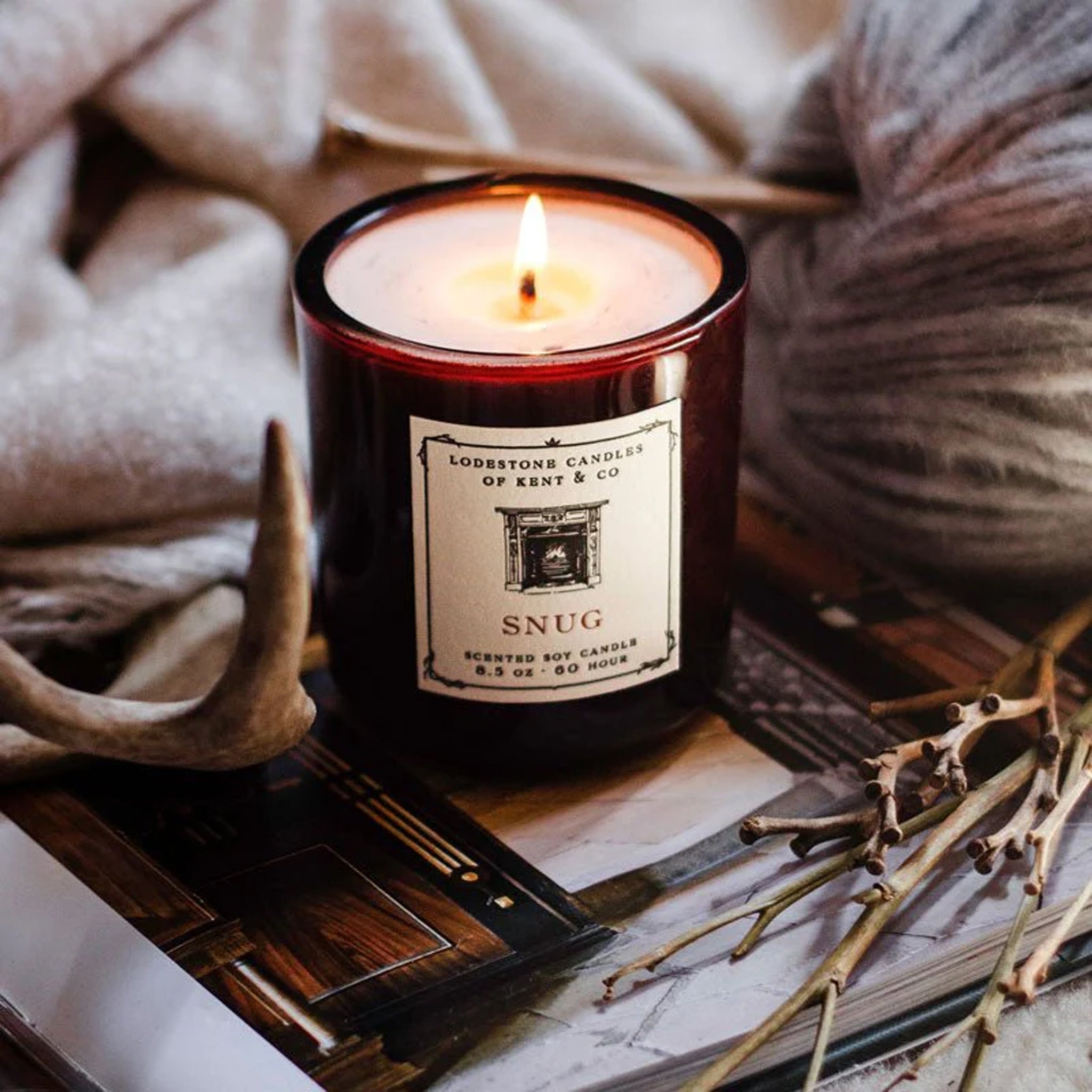 Lodestone Snug Candle on a table at Addison West