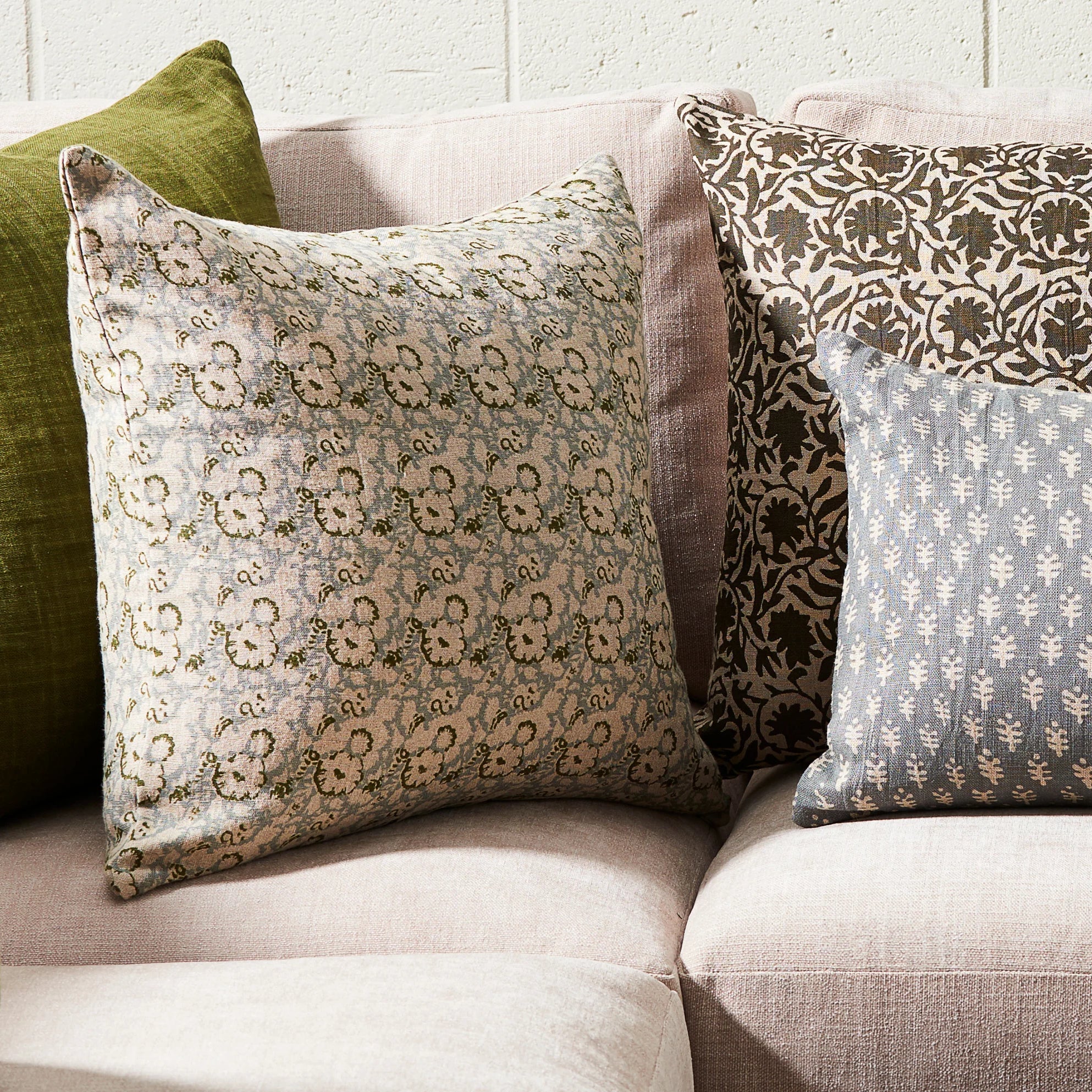 Lola Pillow 22x22 on a sofa at Addison West