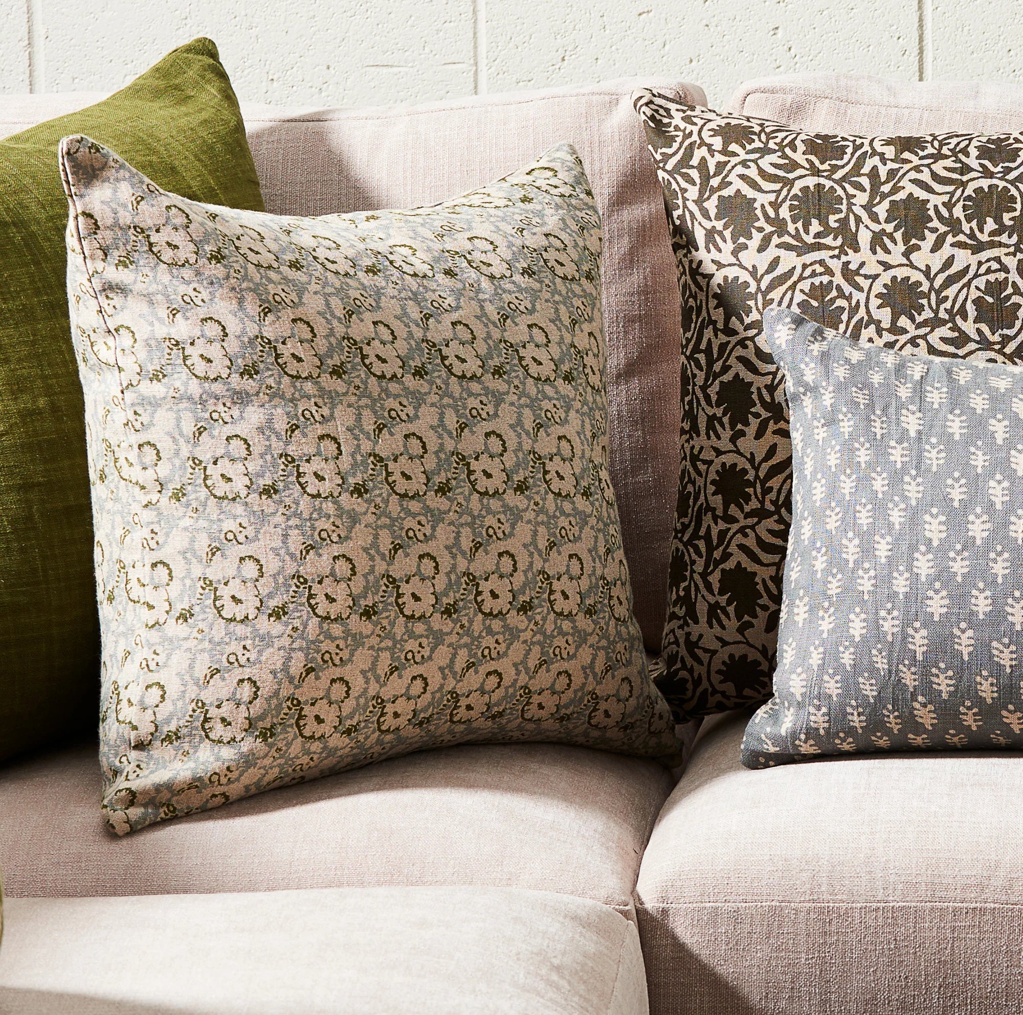 Lola Pillow 22x22 on a sofa at Addison West