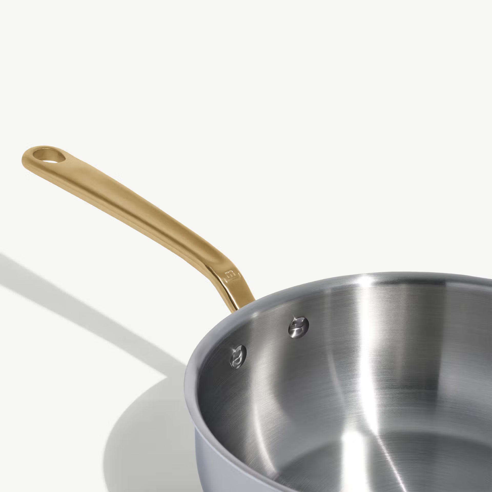 Made In Stainless Clad 3 qt. Saucier with Lid in Antique Brass on a white background at Addison West