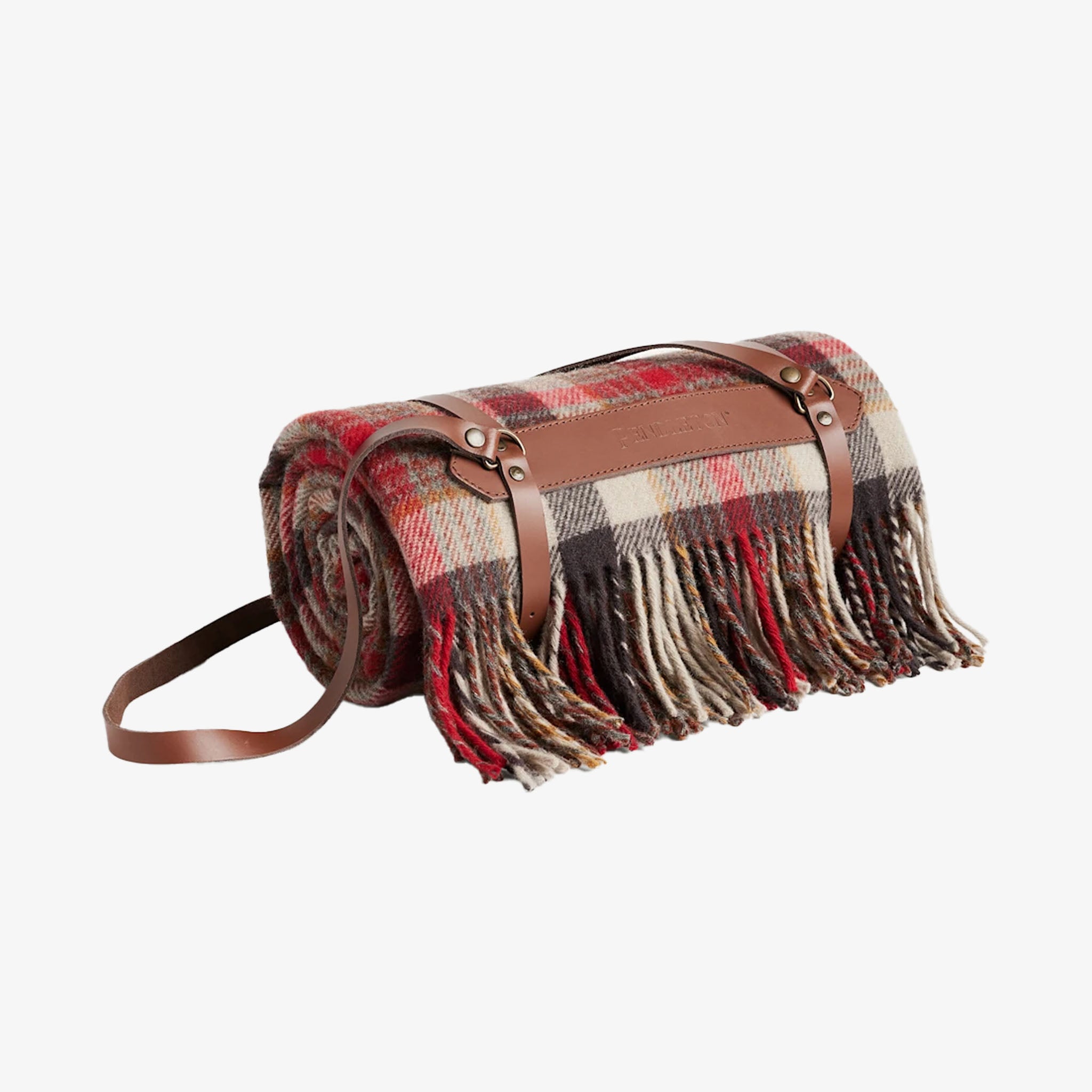 Roll-up plaid blanket with fringes and leather straps on a white background