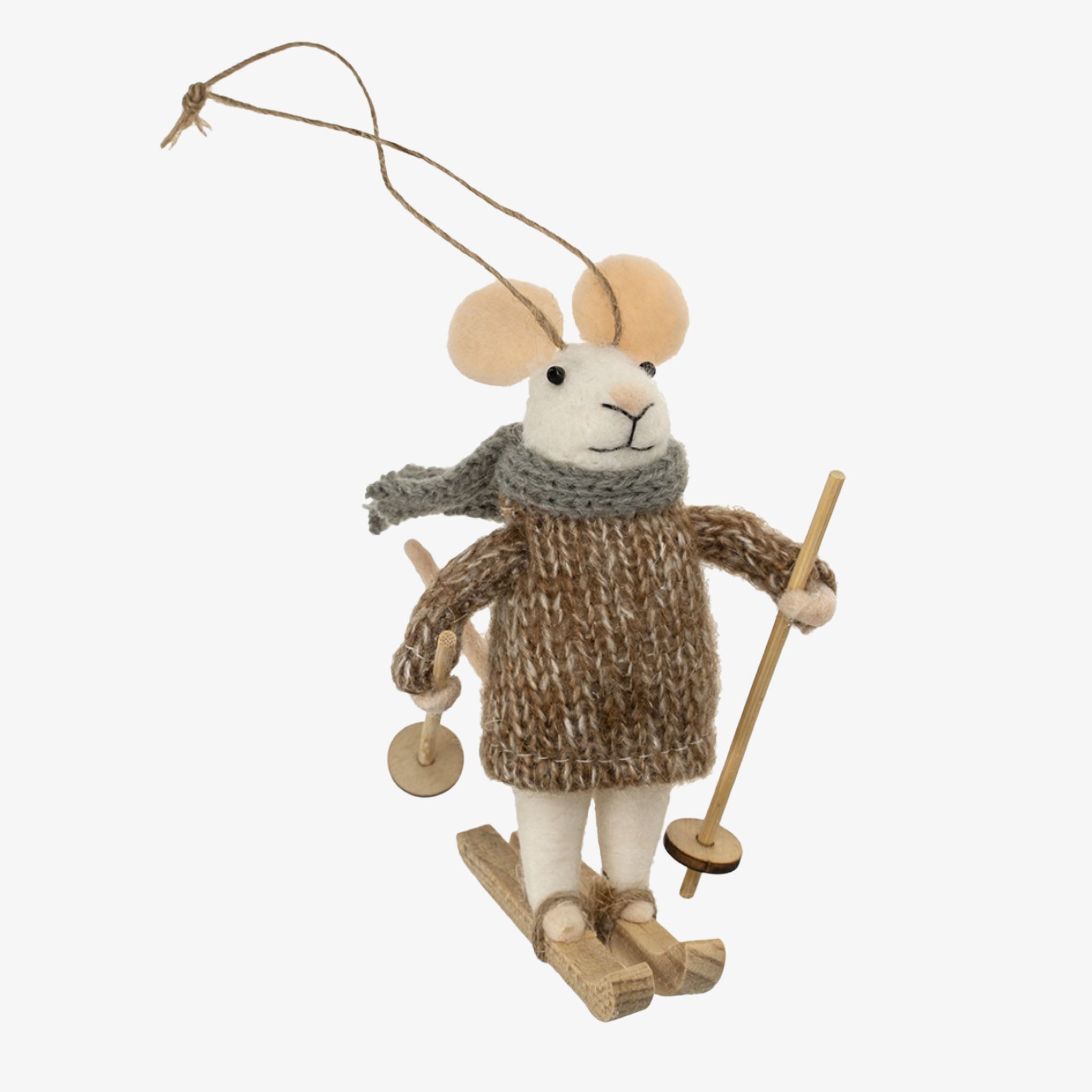 Decorative mouse ornament wearing a sweater, scarf, and skis on a white background