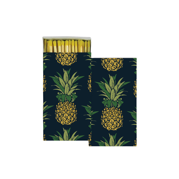Navy box of matches with gold pineapples on a white background