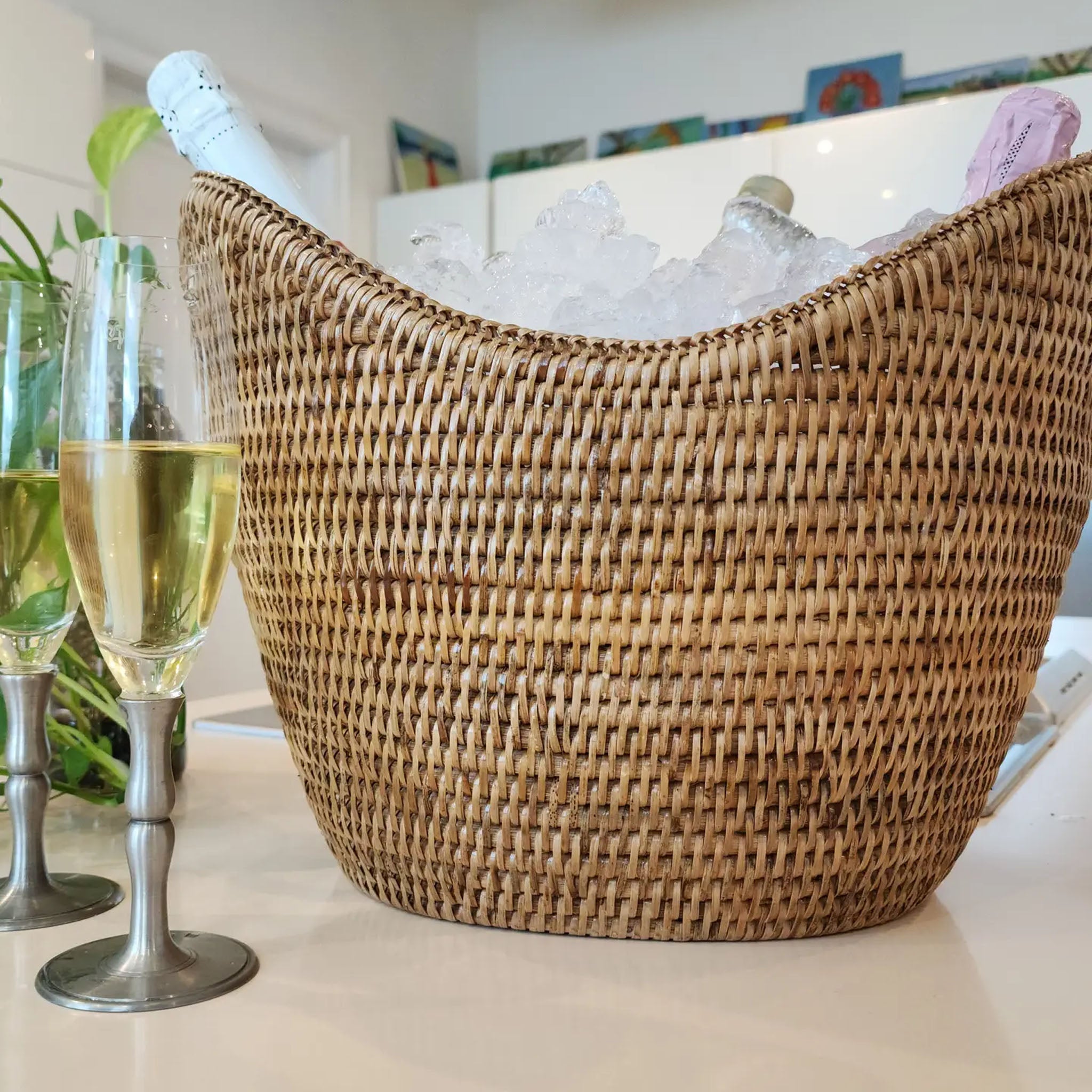 Rattan Champagne Bucket with Acrylic Insert on a kitchen table at Addison West