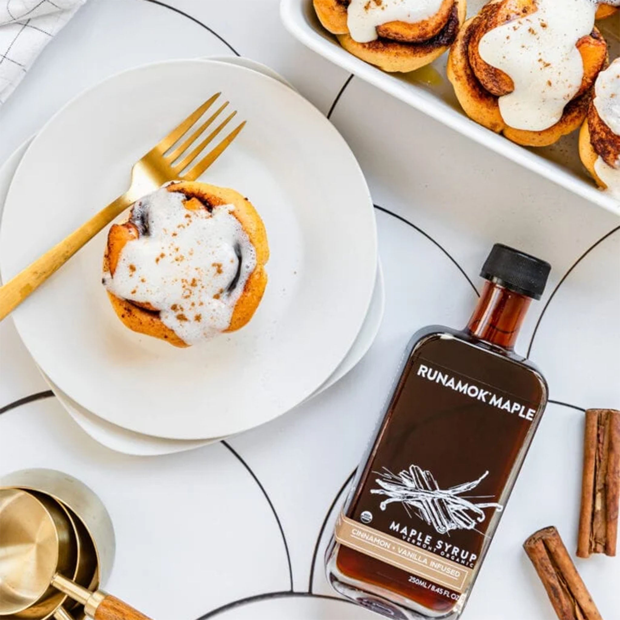 Runamok Cinnamon & Vanilla Infused Maple Syrup on a table with food at Addison West