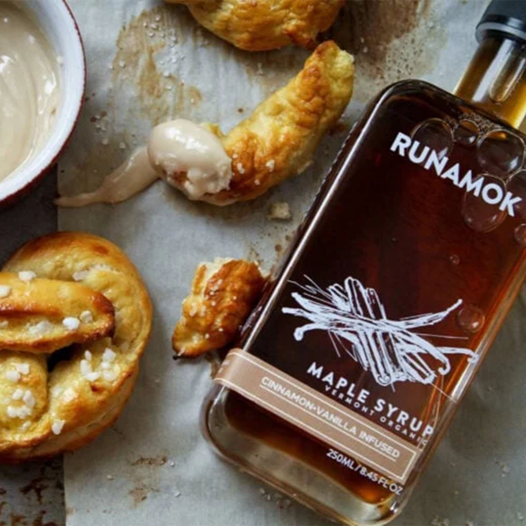 Runamok Cinnamon & Vanilla Infused Maple Syrup on a table with food at Addison West
