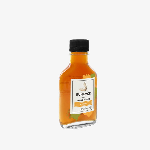 Small bottle of Runamok Orange Maple Bitters on a white background