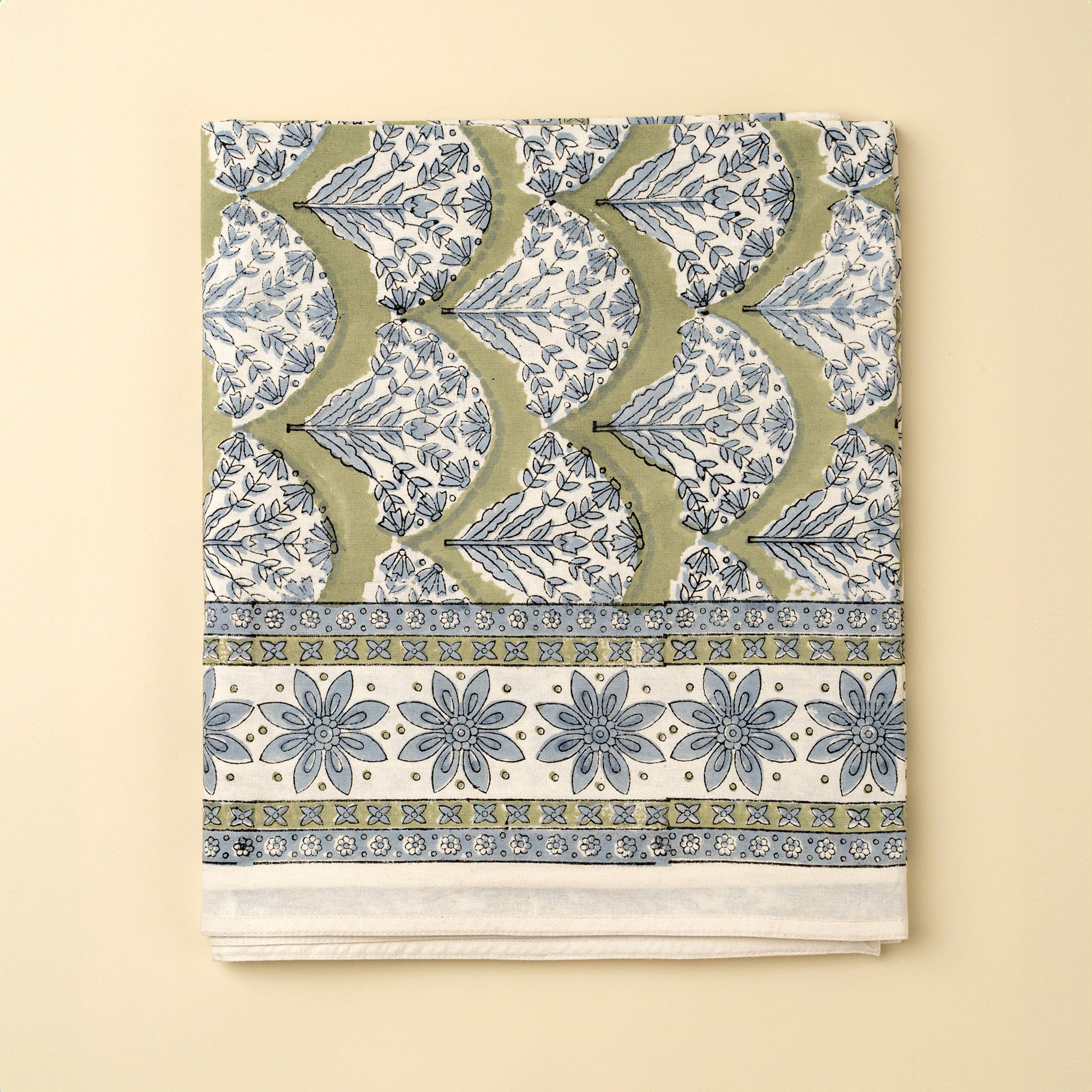 Summer Sage Block Print Tablecloth on a beige background at Addison West