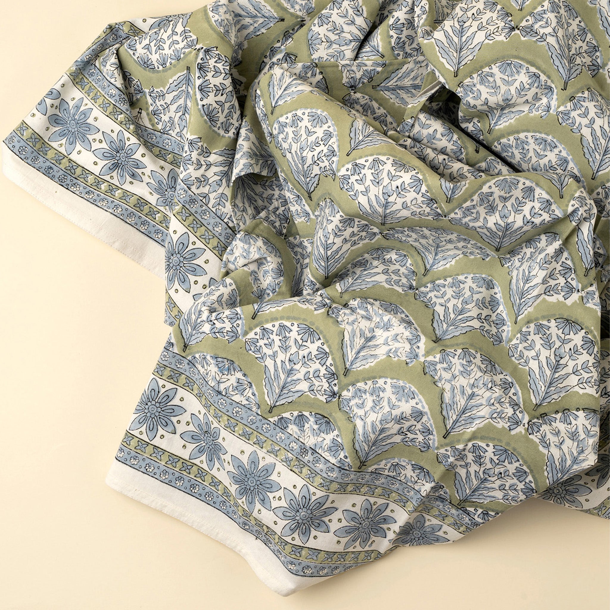 Summer Sage Block Print Tablecloth on a beige background at Addison West