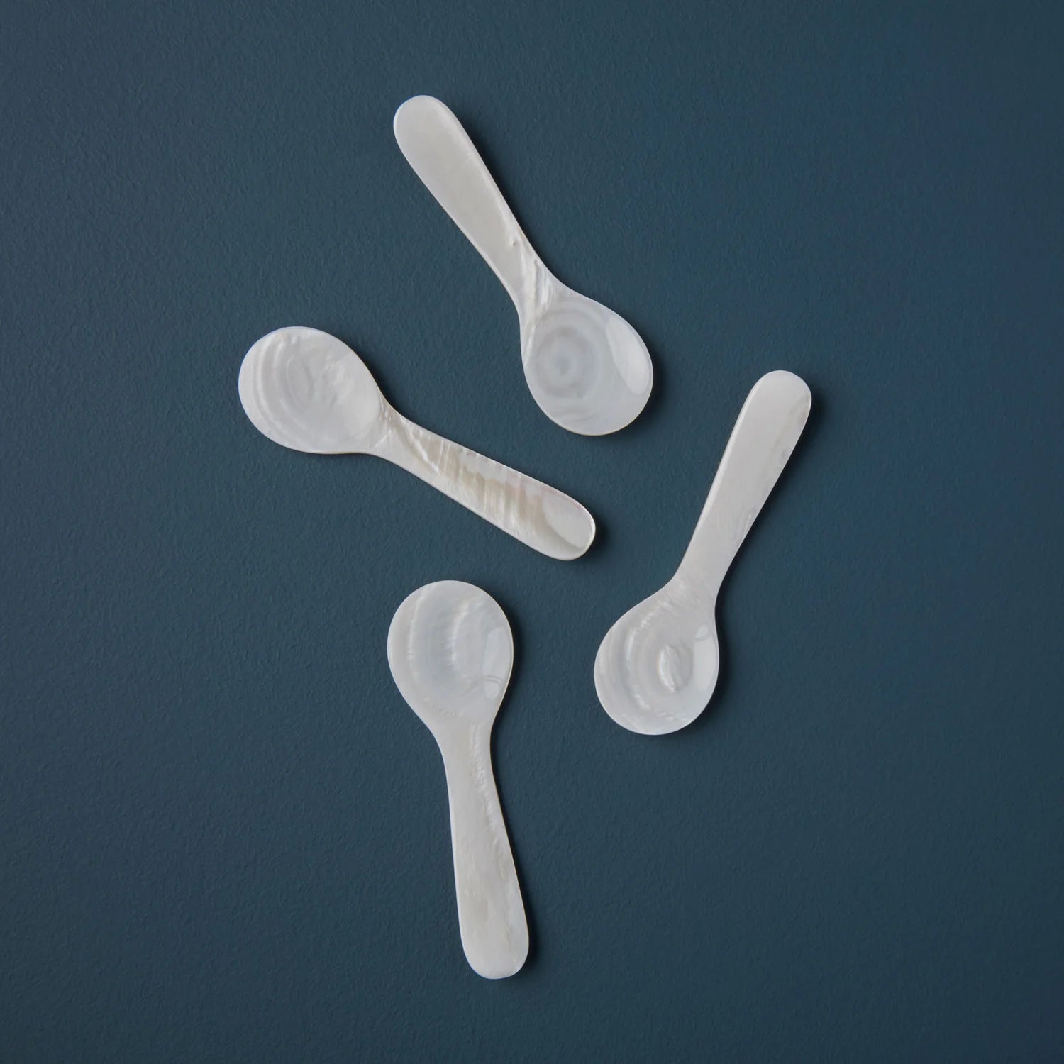 Mini Mother of Pearl Spoon on a blue background at Addison West
