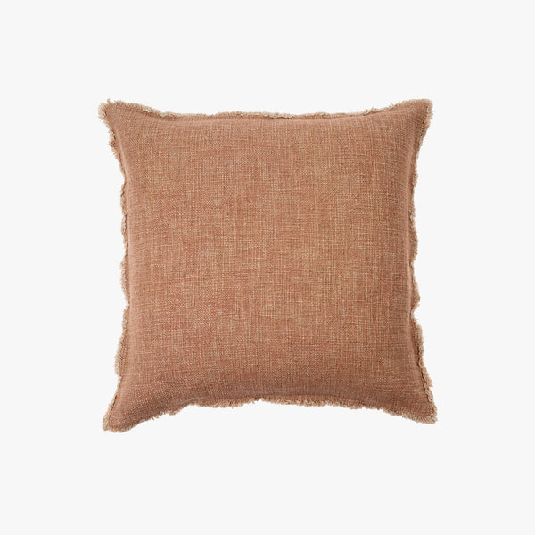 Dusty rose square linen pillow with slightly frayed edges on a white background