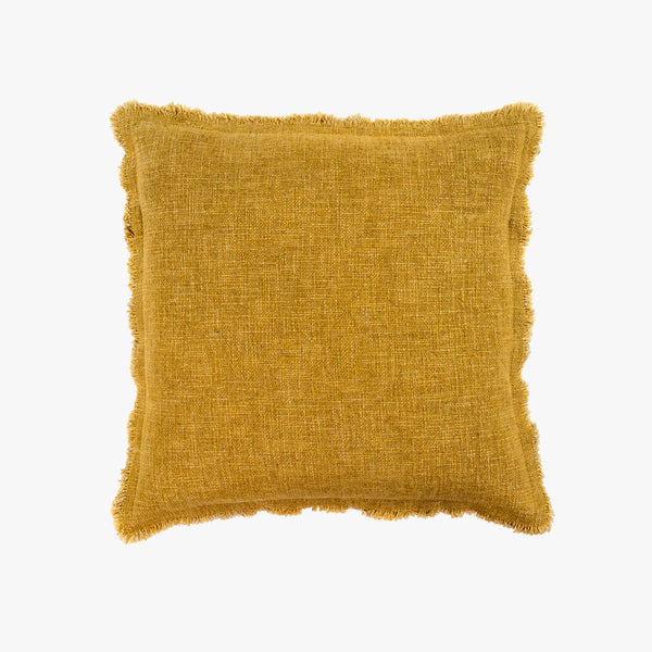 Mustard yellow square linen pillow with slightly frayed edges on a white background