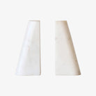 Set of two triangular marble bookends on a white background