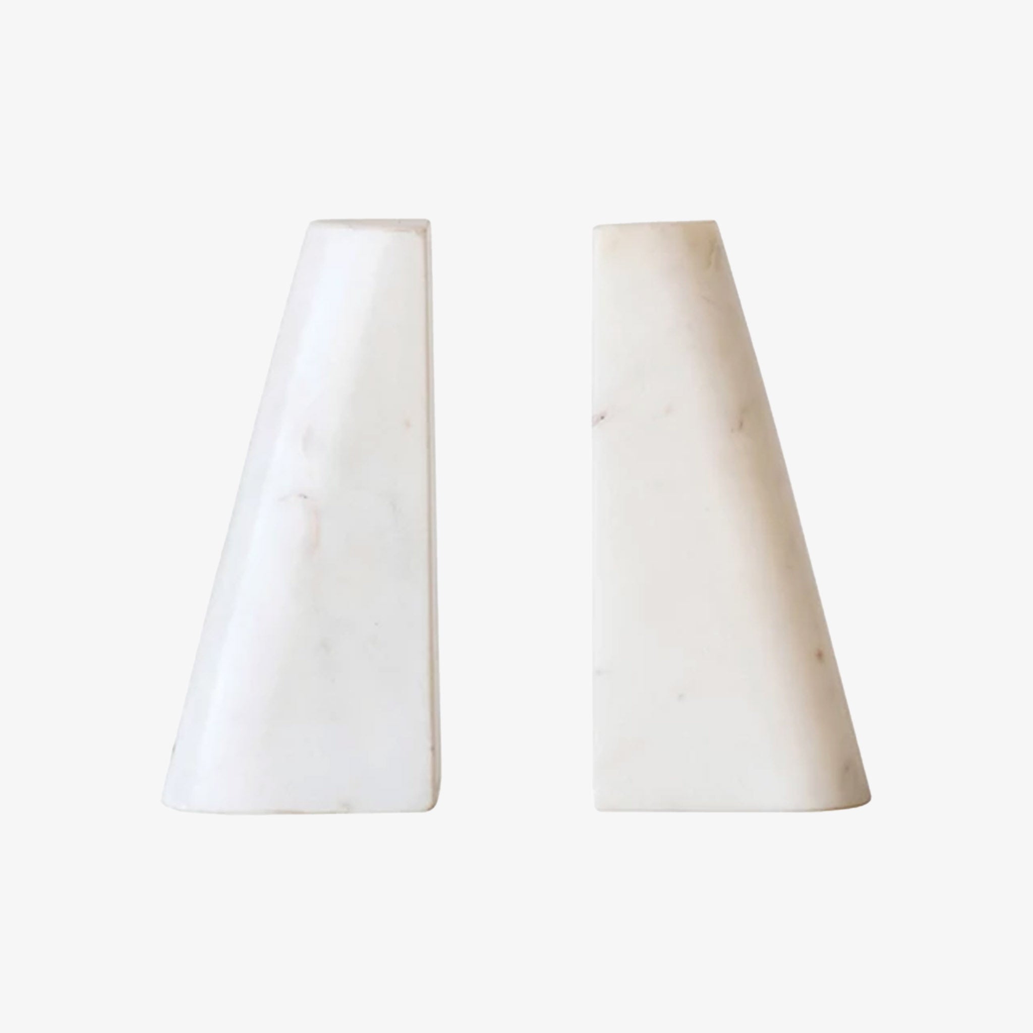 Set of two triangular marble bookends on a white background